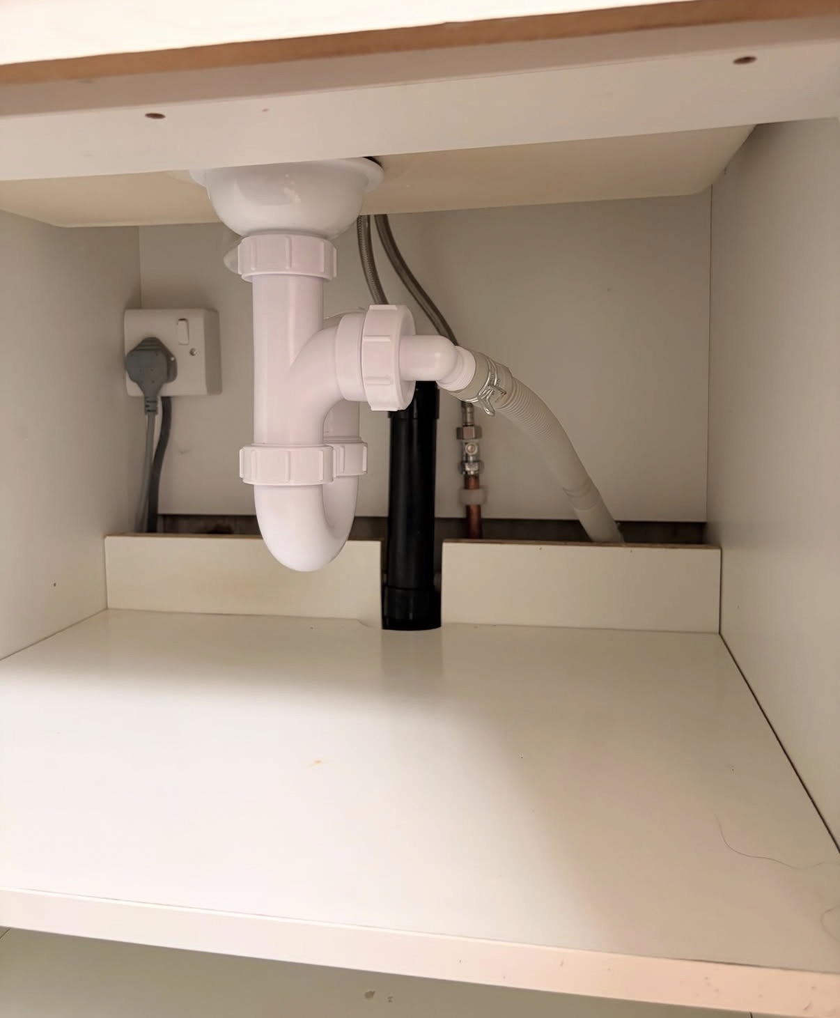 Under-sink plumbing by Parallel Property Services