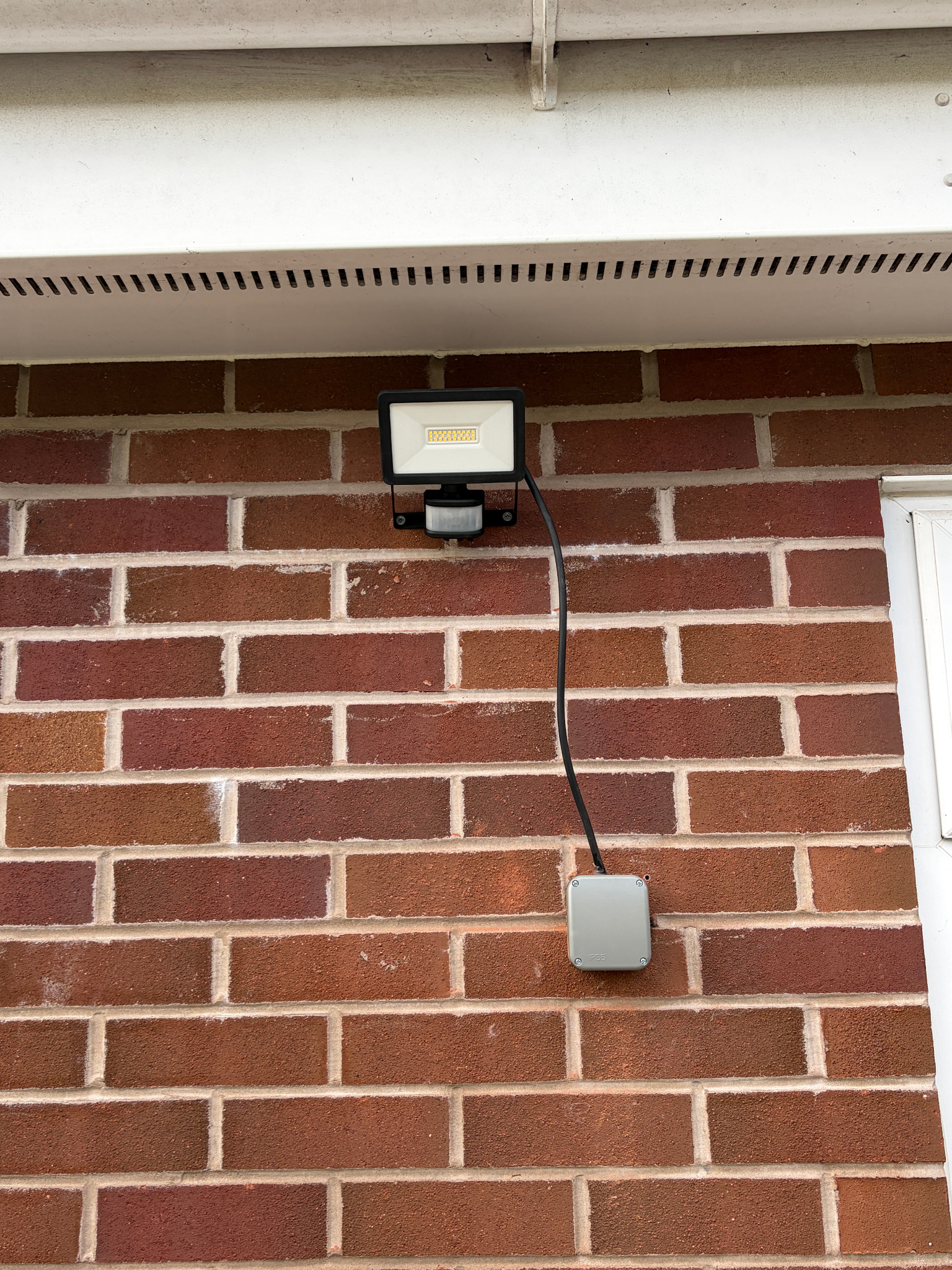Outdoor floodlight with PIR sensor installed by Parallel Property Services
